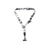 Correa para teléfono Thread con estampado de vaca en blanco y negro, con mosquetón metálico y ajuste deslizable.