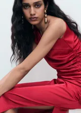 Vestido midi de satén rojo, con diseño asimétrico de un solo hombro, fruncido lateral, tajo pronunciado en un lateral y cierre de cremallera.