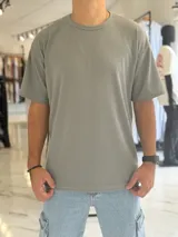 Remera oversize de tejido de punto color beige, de manga corta y cuello redondo.