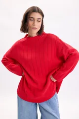 Sweater de punto liso en color rojo, con cuello redondo y diseño holgado de manga larga.