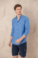 Camisa de lino color beige con cuello mao, corte slim fit y mangas 3/4 con botón para sujetar.