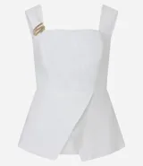 Blusa peplum sin mangas confeccionada en viscosa blanca con escote recto, breteles anchos y traspase delantero. Presenta tejido texturizado, adorno en los breteles y forro.