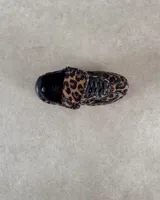 Zapatillas deportivas de cuero vacuno con estampado animal print de vaca en blanco y marrón.