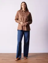 Camisa color verde oliva de lyocell, marca Cyrus. Tiene cuello con solapa, abertura central con botones, mangas 3/4 regulables con presilla y botón, y dos bolsillos delanteros aplicados.