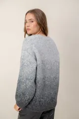 Sweater de punto con escote en V, diseño de mangas largas y efecto degradado que transiciona de un tono crema en la parte superior a un tono beige en la parte inferior.