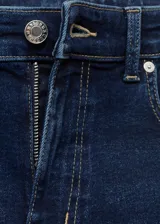 Jeans de tiro medio con diseño flare y bajo deshilachado, con cierre de cremallera y botón, trabillas y cinco bolsillos.