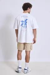 Remera de algodón color verde oliva, corte oversize, con cuello redondo y un pequeño logo bordado en el pecho.