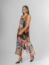 Vestido largo tipo musculosa confeccionado en seda italiana, con diseño de flores abstractas en tonos saturados y nudo regulable en el hombro.