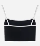 Top deportivo de microfibra con diseño alargado, escote recto y breteles finos. Presenta un detalle de bies contrastante en color blanco en el borde del escote y los breteles. Incluye copas internas para mayor soporte.