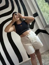 Bermuda de jean color crudo con detalles en negro, tiro alto y ajuste en la pretina.