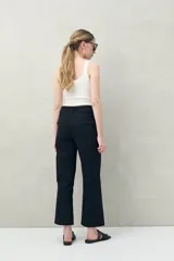 Pantalón de corte recto y calce relajado, confeccionado en algodón color negro. Presenta bolsillos de parche frontales y un diseño de estilo utilitario.