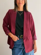 Blazer sastrero color bordó, de diseño clásico con solapas frontales, mangas largas con puños vueltos y bolsillos laterales con solapa. La prenda se encuentra completamente forrada.