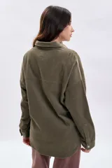 Sobrecamisa de pana color verde, con cuello clásico, cierre frontal con botones metálicos y dos bolsillos delanteros con solapa.