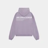Hoodie oversize color lila con capucha y estampado en la espalda con el logo de Eme Studios y texto que dice "Always grateful for my roots, crafted with care 5135, Veteran Collection".