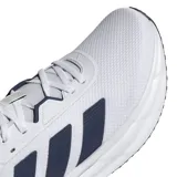 Championes de running Adidas Galaxy 7, color blanco con detalles en azul marino. Presentan un diseño de malla transpirable, cierre con cordones y suela con tecnología Cloudfoam para mayor amortiguación.