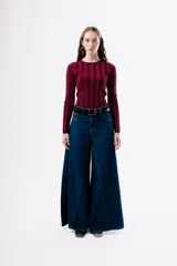 Top de tejido de punto ajustado al cuerpo, con diseño de rayas verticales en tonos bordó y rojo. Presenta cuello redondo y mangas largas.