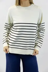 Buzo de tejido fino con diseño de rayas horizontales en contraste. Presenta cuello redondo, mangas largas y terminaciones acanaladas en cuello, puños y cintura.