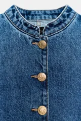 Chaqueta de denim azul con cuello redondo, manga larga y cierre frontal con botones dorados. Presenta costuras verticales decorativas y puños con botones a juego.