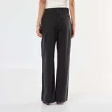 Pantalón de jean corte wide leg, de tiro alto y color gris lavado, con cierre frontal y cinturón fino del mismo tejido.