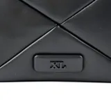 Bandolera negra de formato rectangular con solapa, confeccionada en símil cuero liso acolchado con diseño de costuras en X. Presenta herrajes plateados, incluyendo una cadena decorativa frontal y correa regulable. Cuenta con placa metálica con el logo de la marca en la parte inferior.