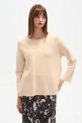 Sweater negro liso, holgado, con cuello a la base y broches decorativos en el lateral.