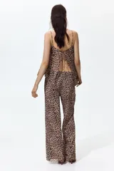 Pantalón de corte holgado en malla transparente, con estampado de leopardo, cintura elástica y piernas rectas.