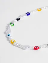 Collar corto de perlas sintéticas con cuentas de vidrio de colores con diseño de ojo turco. Cierre de mosquetón.