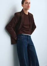 Jean de corte wide leg y tiro bajo, confeccionado en tejido de algodón estilo denim. Presenta diseño clásico de cinco bolsillos, cierre de botón y cremallera, y trabillas en la cintura.