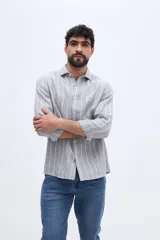 Camisa de manga larga con diseño de rayas verticales, confeccionada en mezcla de lino y algodón, con cuello camisero y cierre frontal de botones.