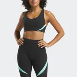Top deportivo Reebok de soporte medio, confeccionado en tela Nylux con diseño de espalda nadadora. Presenta un color negro predominante con detalles en color menta en los laterales y copas internas para mayor soporte.