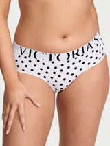 Panty hipster de tiro bajo en color blanco con estampado de lunares negros y cintura elástica con el logotipo de la marca.