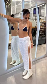Pollera larga blanca de encaje con tajo lateral y tiro bajo.
