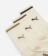 Pack de tres pares de medias de caña alta Puma, confeccionadas en algodón. Incluye un par en color beige, un par en gris claro y un par en gris oscuro, con detalles de líneas en los bordes superiores y el logo de la marca estampado.