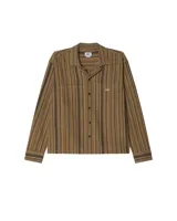 Camisa de manga larga Obey con cuello tipo cubano y cierre frontal de botones. Presenta un diseño a rayas verticales en tonos tierra y un bolsillo frontal con el logo de la marca bordado.