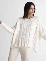 Sweater color crema con cuello redondo y diseño de trenzas grandes.