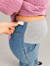 Jean maternal wide leg color azul claro lavado, con faja gris elastizada de tiro alto para acompañar el crecimiento de la panza, bolsillos delanteros funcionales y corte amplio y relajado.