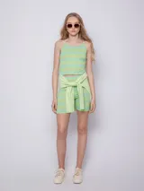 Top sin mangas color verde con rayas horizontales celestes, textura acanalada, escote redondo y tirantes finos.