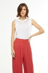 Pantalón palazzo rojo con finas rayas verticales blancas, de tiro alto y corte holgado.