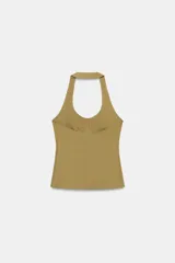 Top de cuello halter con diseño ajustado y escote con costuras tipo corset en el busto. Presenta espalda descubierta y bajo recto.
