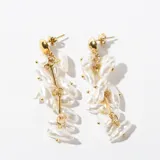 Aros colgantes dorados con perlas blancas irregulares.