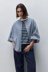 Pantalón jean de tiro alto con calce straight y pierna recta, confeccionado en denim de aspecto limpio. Cuenta con cinco bolsillos, cierre frontal con botón y presillas para cinturón.