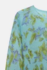 Jersey de punto Zara con cuello redondo y manga larga, con estampado floral a contraste en tonos verdes y morados sobre base celeste.
