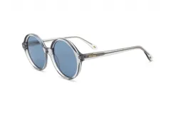 Lentes de sol Prune modelo Glenda, con armazón de acetato transparente grisáceo y cristales redondos de color azul.
