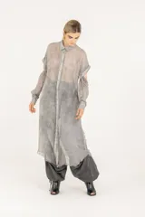 Camisa larga o vestido camisero de viscosa y seda, color gris con efecto teñido en frío, de tejido semitransparente, cuello clásico, mangas largas desmontables y cierre frontal con botones.