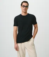 Remera de manga corta Marfinno para hombre, de color blanco y con cuello redondo. Confeccionada en tejido texturizado de mezcla de algodón y poliéster.
