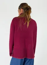Sweater de cuello alto en color beige, con diseño de punto liso y terminaciones acanaladas en puños y ruedo. Presenta aberturas laterales en el bajo y un detalle de borde desflecado en el ruedo y los puños.