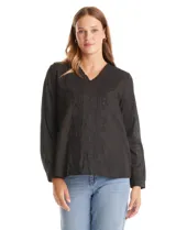 Blusa de algodón color negro con bordados florales al tono. Presenta escote en V con terminación festoneada y mangas largas con puños fruncidos.