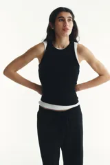 Musculosa de punto acanalado color negro, con cuello redondo y bajo recto.