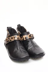 Bota baja estilo botín de cuero color rojo, con hebilla dorada y elástico negro.