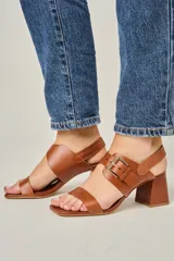 Sandalias de cuero color marrón, con punta cuadrada, tira ancha sobre los dedos, tira al tobillo con hebilla dorada y taco bloque de 7 cm.